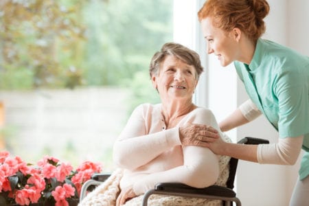 woman in wheelchair in nursing home